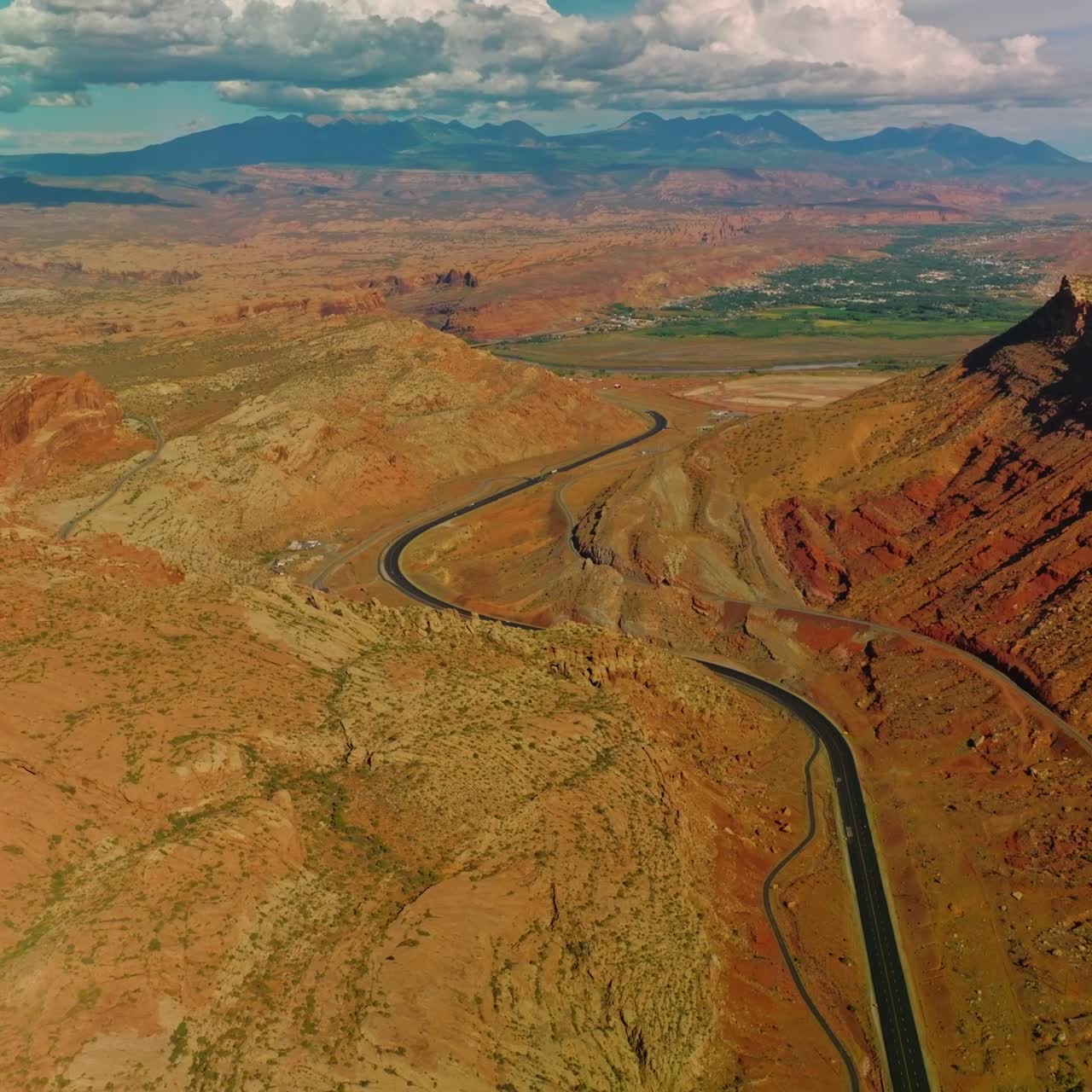 Amazing scenery of splendid canyons lit with sun. Clouds in blue sky at backdrop. Aerial perspective