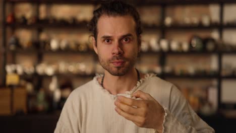 man holding a cup of tea in a traditional tea house