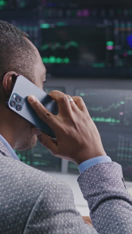 businessman on phone call in stock market trading room