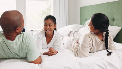 Happy-man,-woman-and-child-on-bed