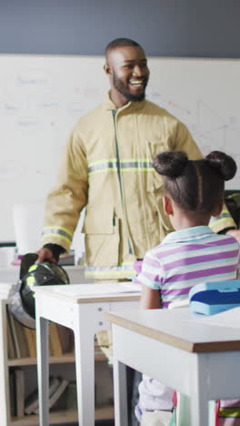 video of happy african american teacher with class of diverse pupils during ohs lesson