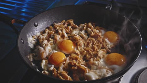 frying sweet and sour eggs in a frying pan, close up view in home kitchen