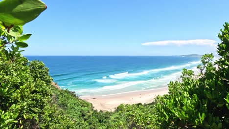 a tranquil glimpse of the ocean framed by greenery