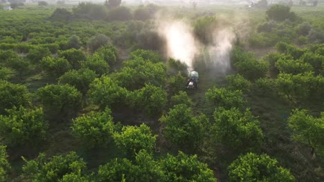 tractor spraying pesticide drone aerial view, pesticides or insecticide spray on lettuce or iceberg field. pesticides and insecticides on agricultural field in spain
