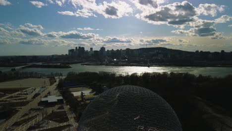 Drone-shot-of-Montreal-and-St-Laurent-river-near-Biosphere,-golden-hour