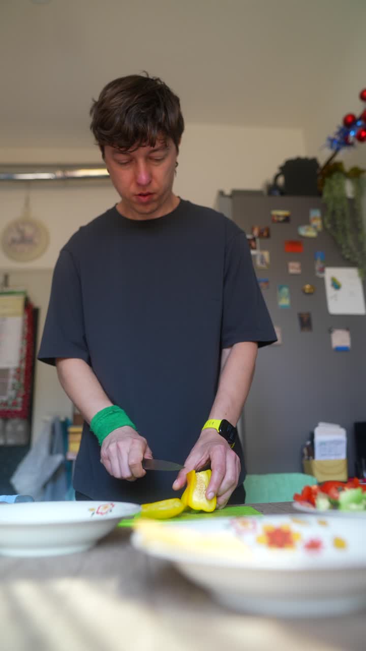 Man Chopping a Yellow Pepper in the Kitchen