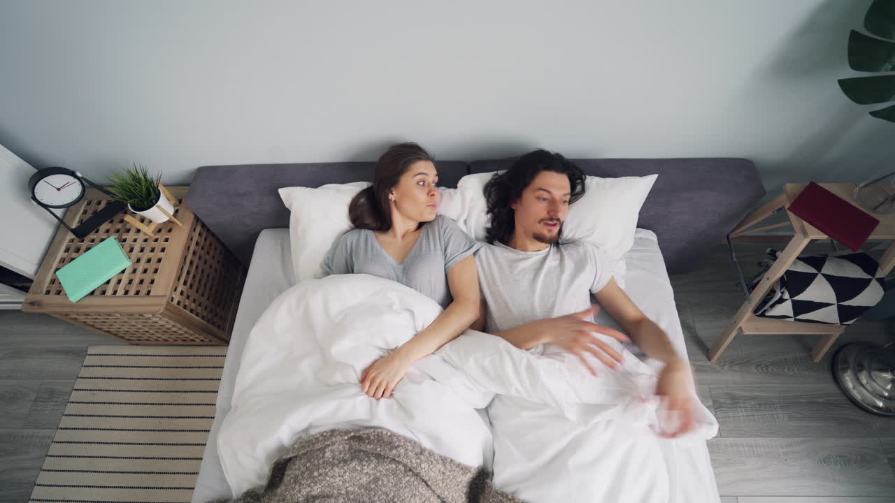 Couple Lying in Bed, Uncomfortable
