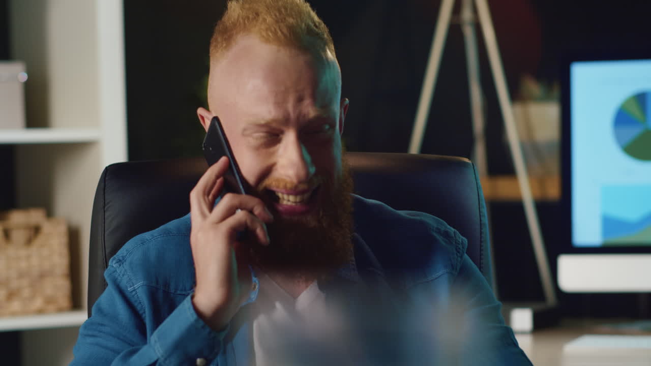 Portrait of businessman talking on smartphone at hipster office.