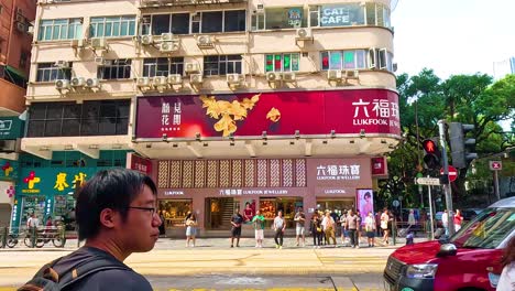 people crossing street near tall buildings