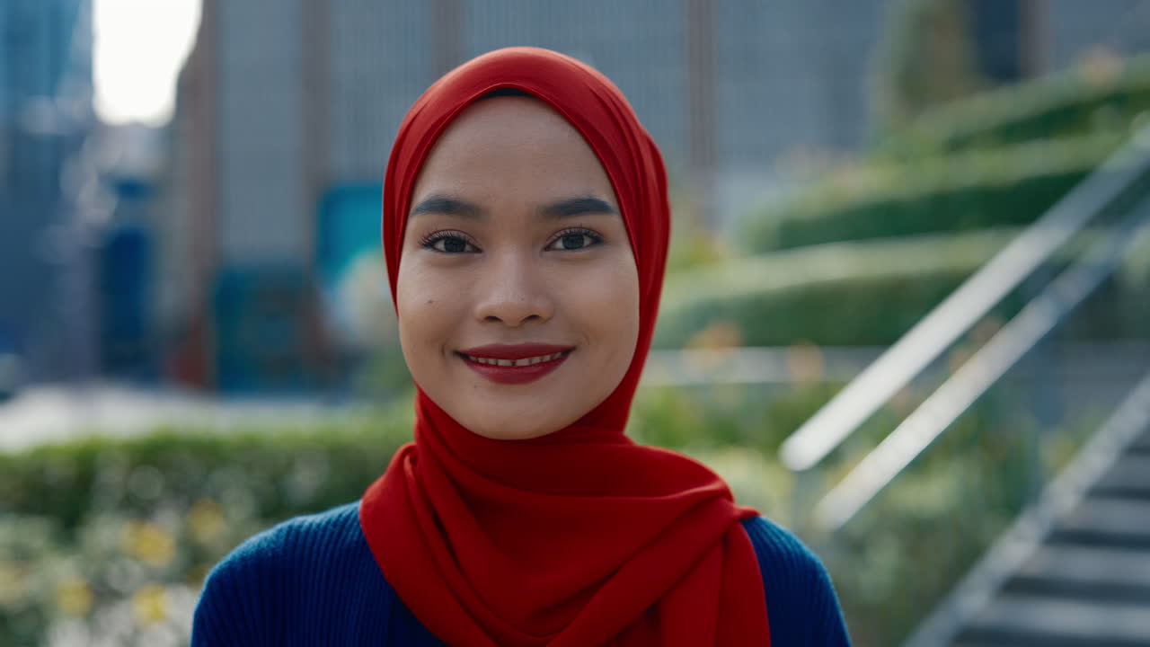 Portrait of a Young Woman in a Red Hijab Outdoors