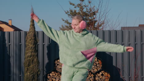 woman dancing outdoors in winter pajamas