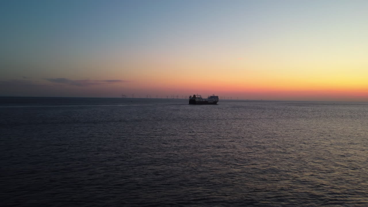 Aerial drone vew of cargo boat near port of Liverpool Great Britain at sunset