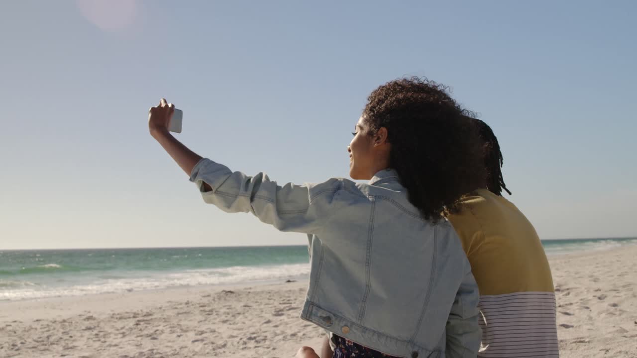 Couple taking selfie with mobile phone on the beach 4k