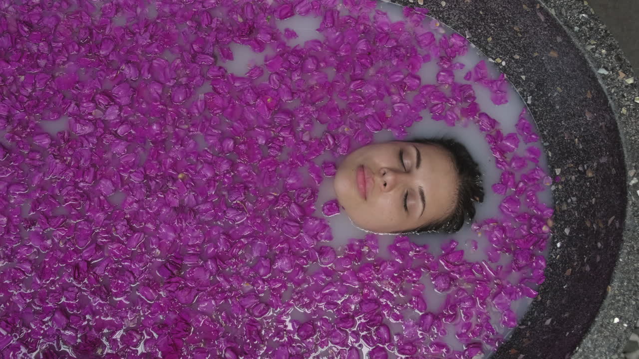 Woman enjoying a relaxing flower bath