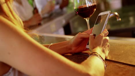 woman using mobile phone in restaurant