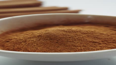 ground cinnamon in a white bowl