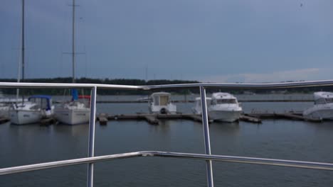 railing on the bow of the boat close-up, blurred yachts against the background