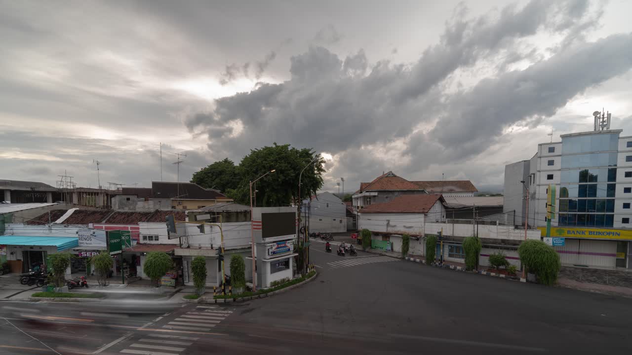 Busy street in an Indonesian city under a cloudy sky