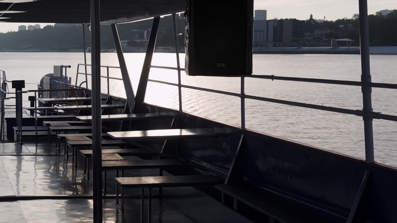 Empty Boat Deck at Sunset on the River with City Skyline