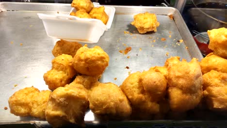 Panning-shot-of-fritters-food-stand