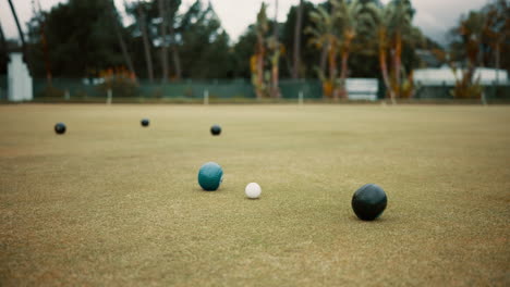 green, lawn bowling and balls on grass