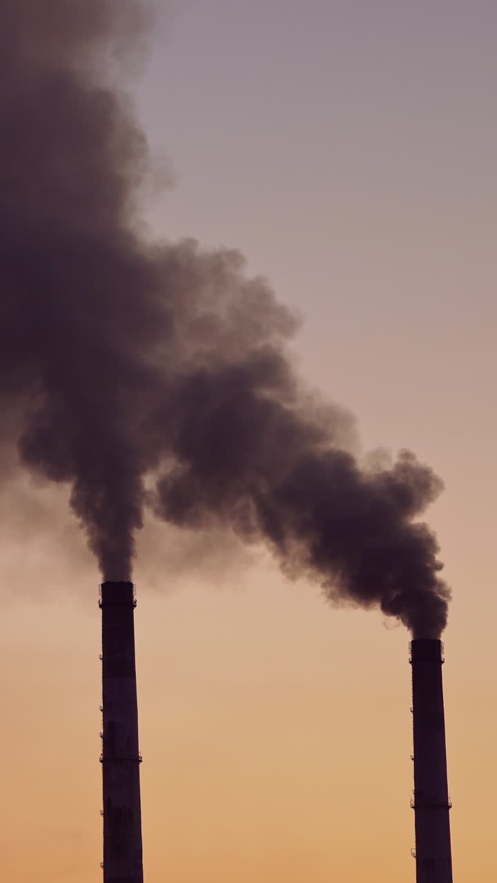 Industrial zone in the city. Air pollution by smoke coming out of two factory chimneys