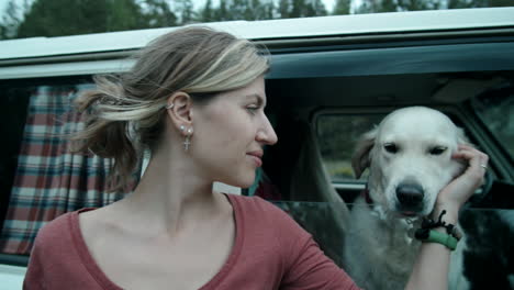 portrait of happy woman and dog in van