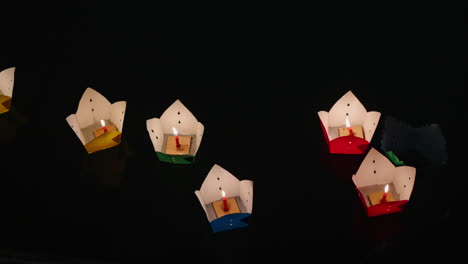 4k close‑up of colourful paper lanterns floating serenely on the river at night in hoi an