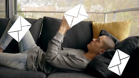 man lying on a sofa and texting 4k