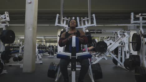 Black-Male-Bodybuilder-Strongman-Athlete-Is-Lifting-Weights-On-Sports-Equipment-in-4K