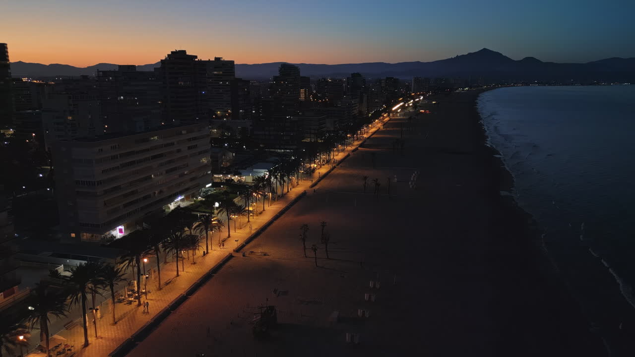 Aerial drone view of the Mediterranean Sea and the Alicante city in Spain at sunset