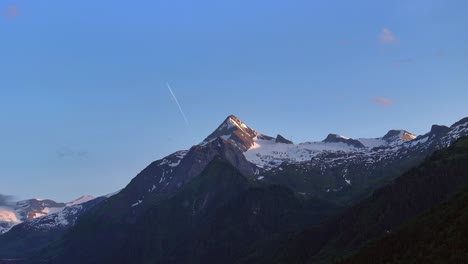 backdrop of clear blue skies the peaks of the austrian alps at sunset