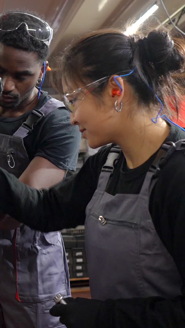 Auto Mechanics Working on Car Engine