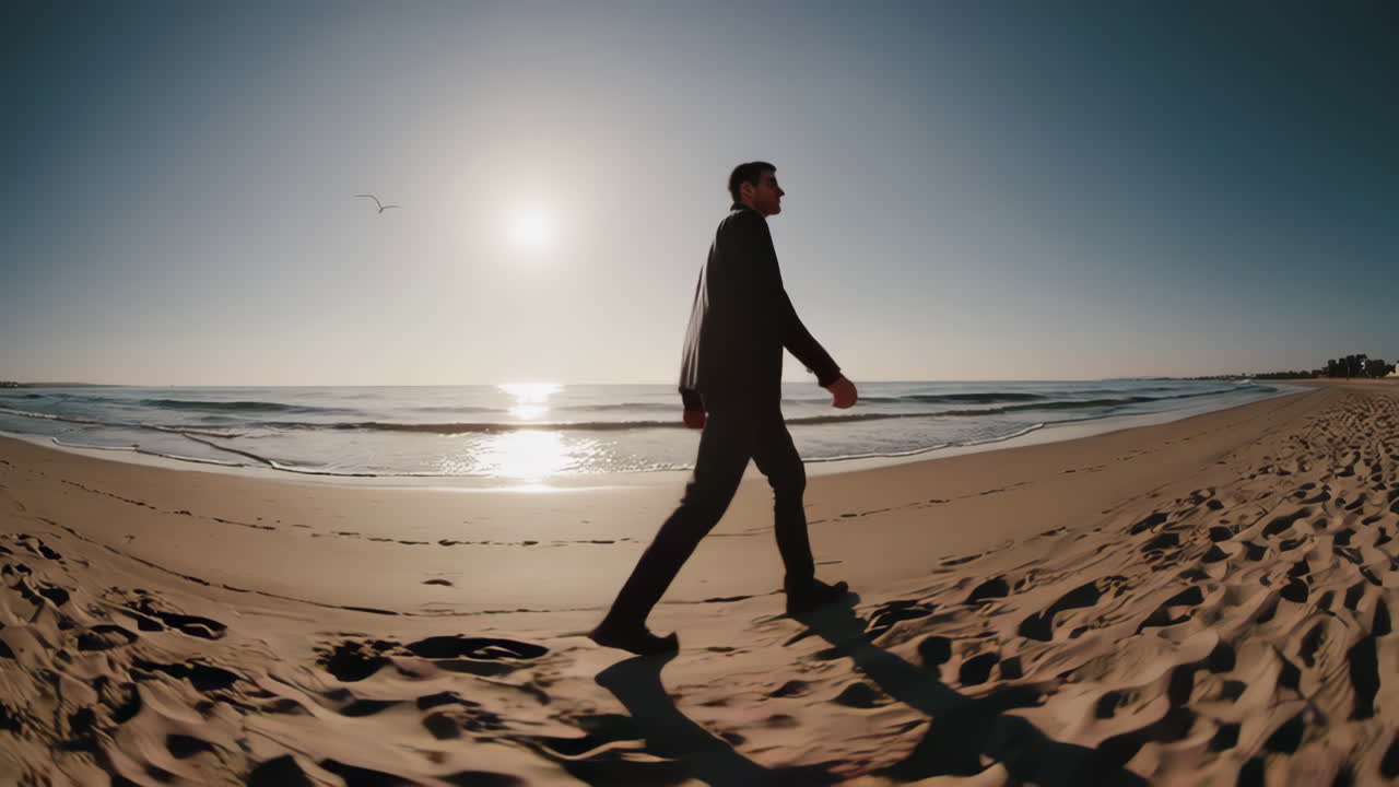 Businessman Walking on the Beach at Sunrise