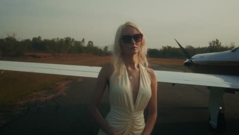 woman in a dress near a private jet