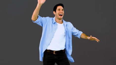 Man-dancing-and-having-fun-on-grey-background