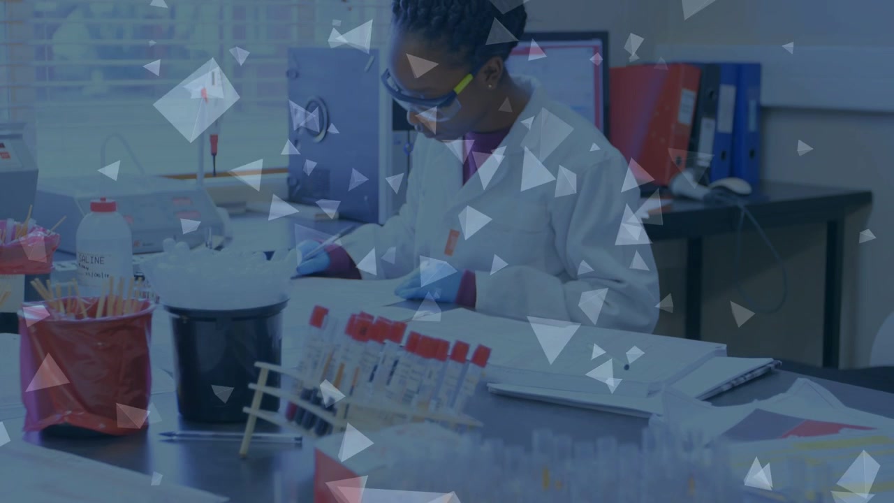 Lab tech checking records then inspecting tubes and noting results while triangles obscure bench