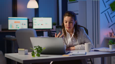 business woman discussing during video conference with partners using smartphone