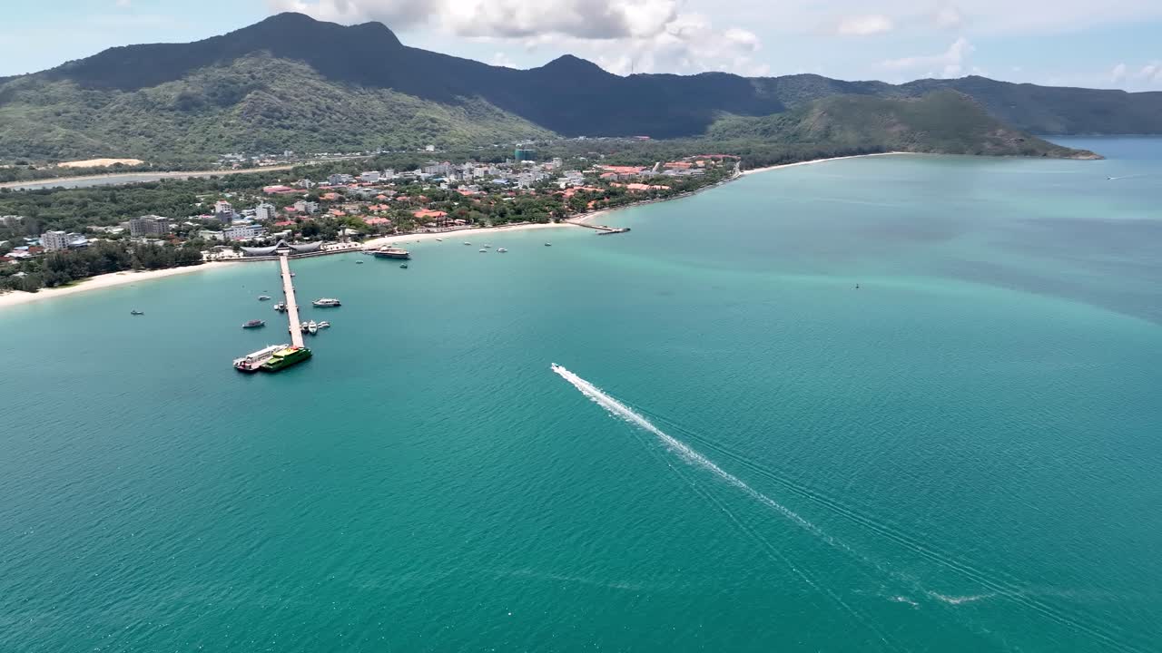 Boat speeds fast through waters wide, cutting waves with graceful glide