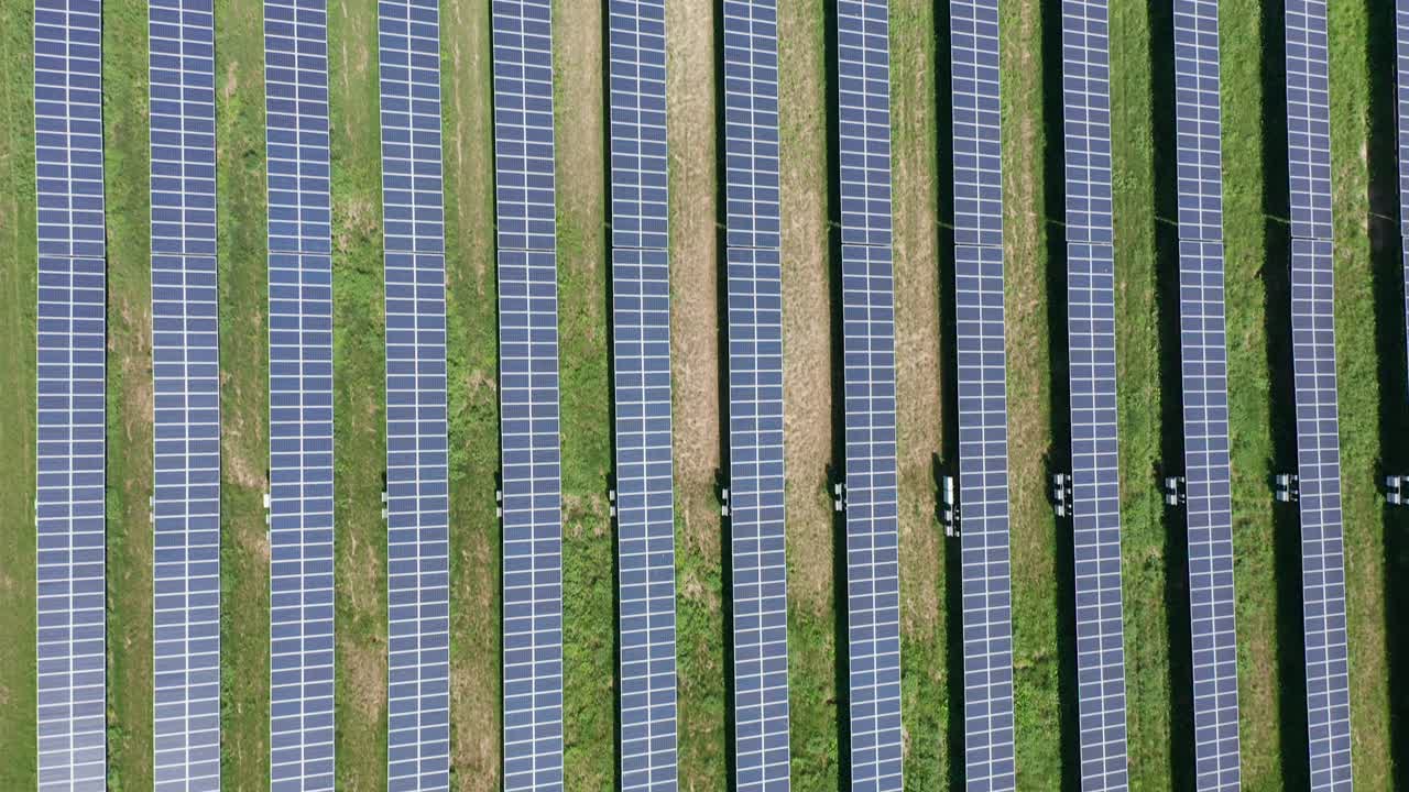 Aerial bird's eye shot flying over an endless solar farm in rural Minnesota