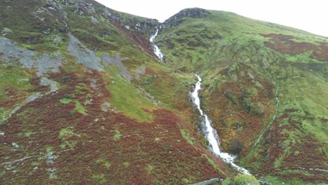 idyllic snowdonia mountain range aber falls waterfalls national park aerial pull back orbit left view