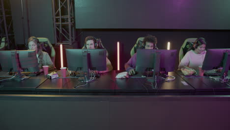 team of four cybersport gamers playing video games in a gaming club 1