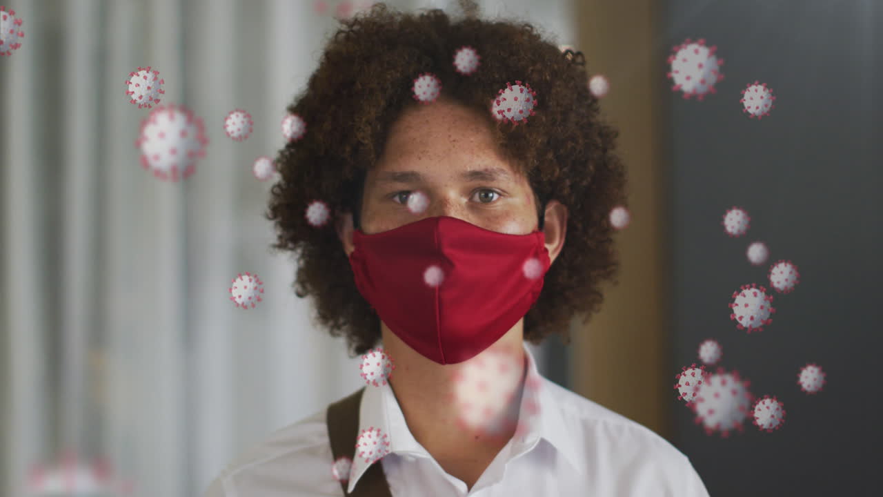 Animation of virus cells over biracial man with face mask