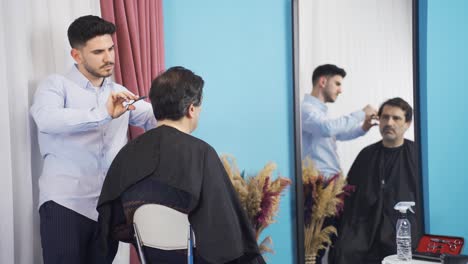 Young-man-shaving-his-father-at-home.