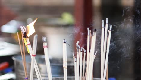 incense sticks burning in a pot