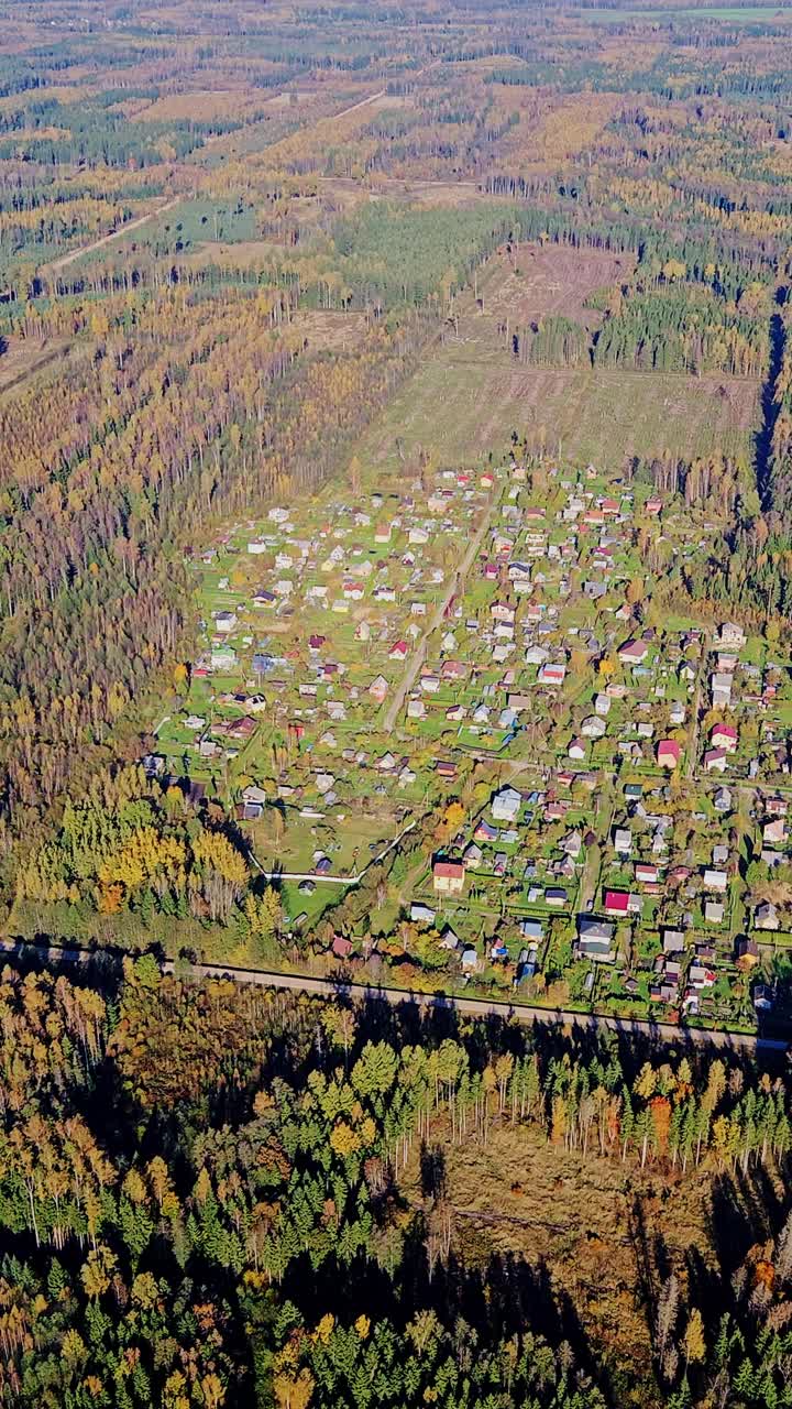 Small Village Nestled in Autumn Forest – Latvia Seen From Helicopter Window