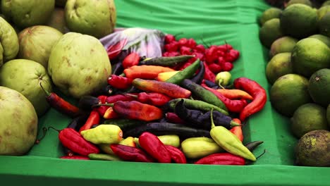 fresh pepers laying on the green karpet of the market shop