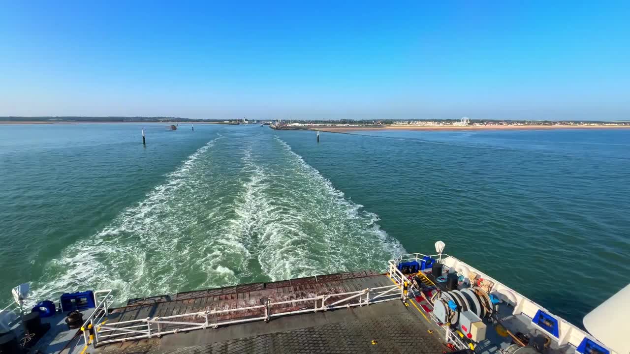 large ship travelling the English channel. Blue water giving rise to a white waves in summer