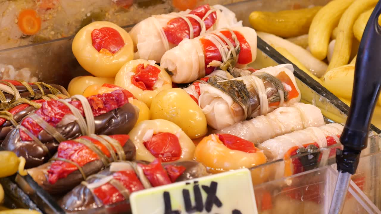 Close-up of various pickled and stuffed vegetables in a food display
