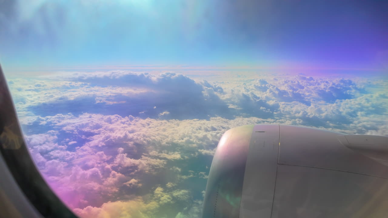 A panoramic shot of an airplane engine with vibrant clouds and sky in the background. The play of light creates a colorful, dreamy effect
